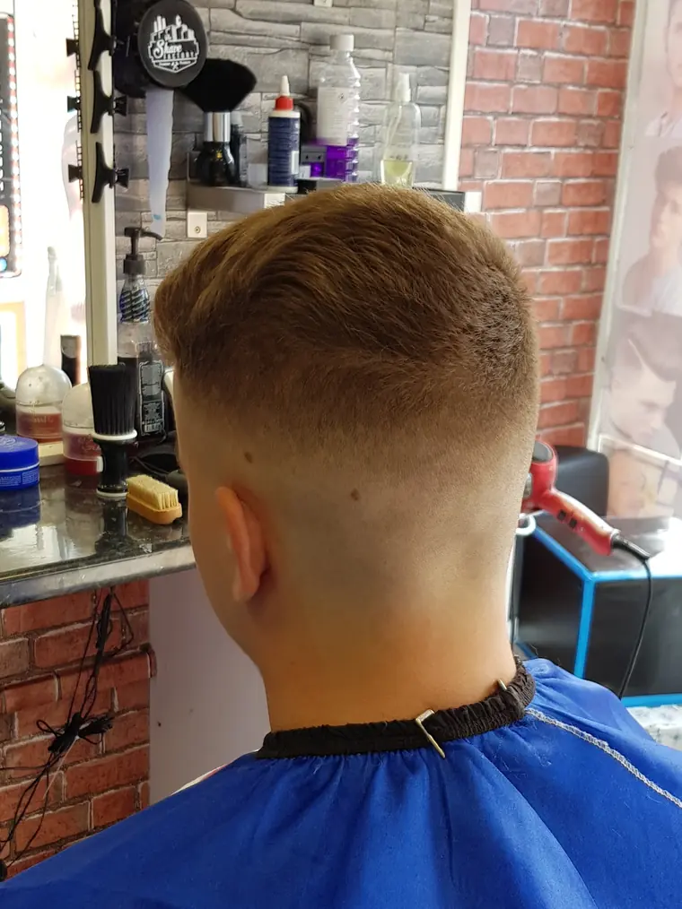 Scissor-over-comb cut against the stone wall, Kurdistan Barbers